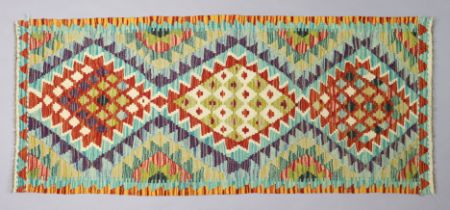 A kilim rug of beige & ivory ground & having repeating multi-coloured floral design to centre within