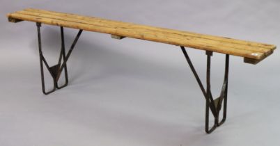 A wooden potting table on black-finish iron fold-away legs, 180cm long x 51cm high.