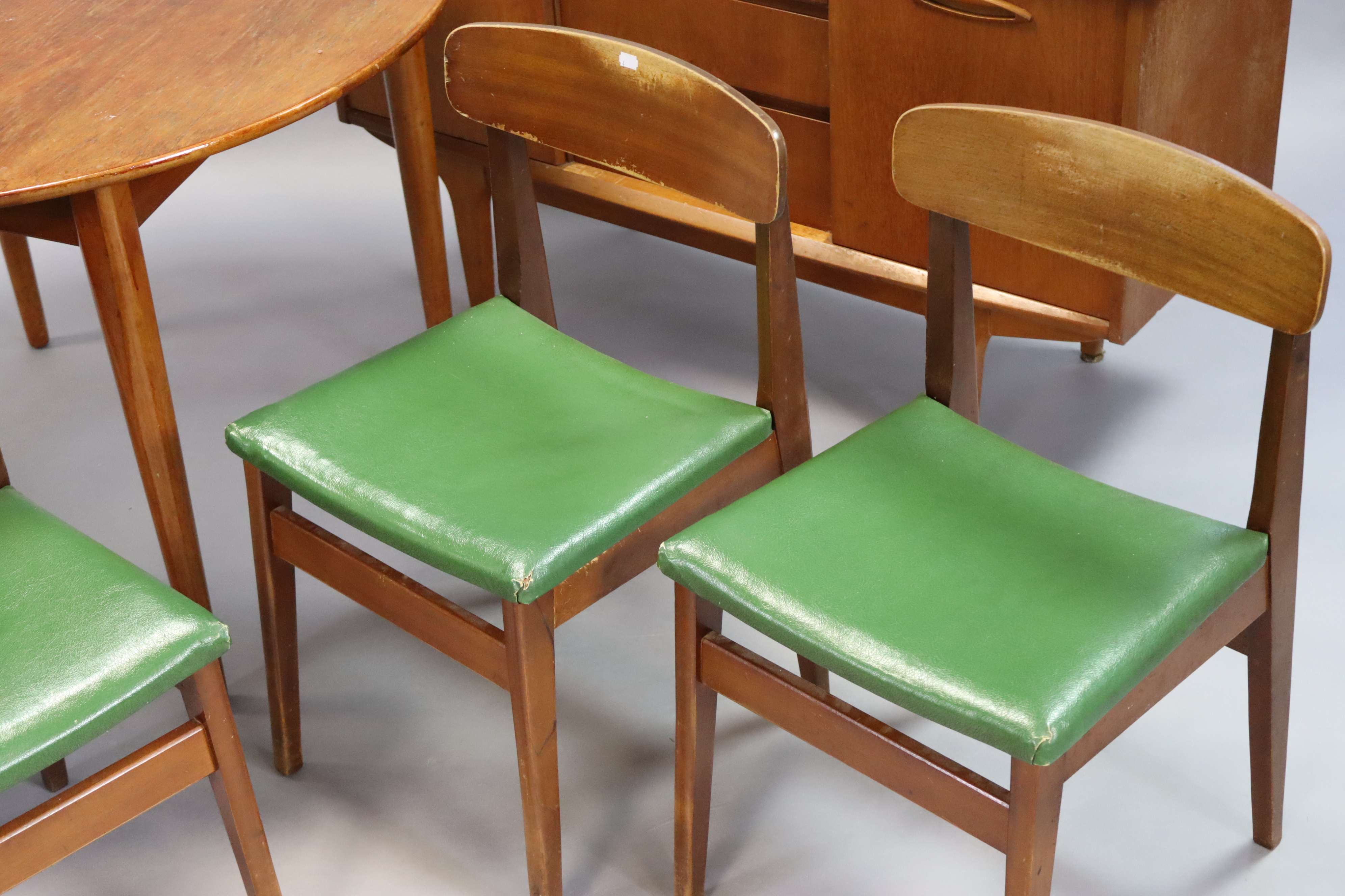 A mid-20th century teak dining room suite comprising of a circular extending table with a centre - Image 3 of 13