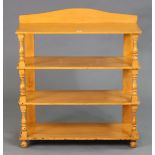 A painted wooden four-tier standing open bookcase with baluster-turned supports & turned feet, 76cm