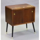 A mid-20th century mahogany vinyl cabinet enclosed by a pair of sliding panel doors, & on ebonised