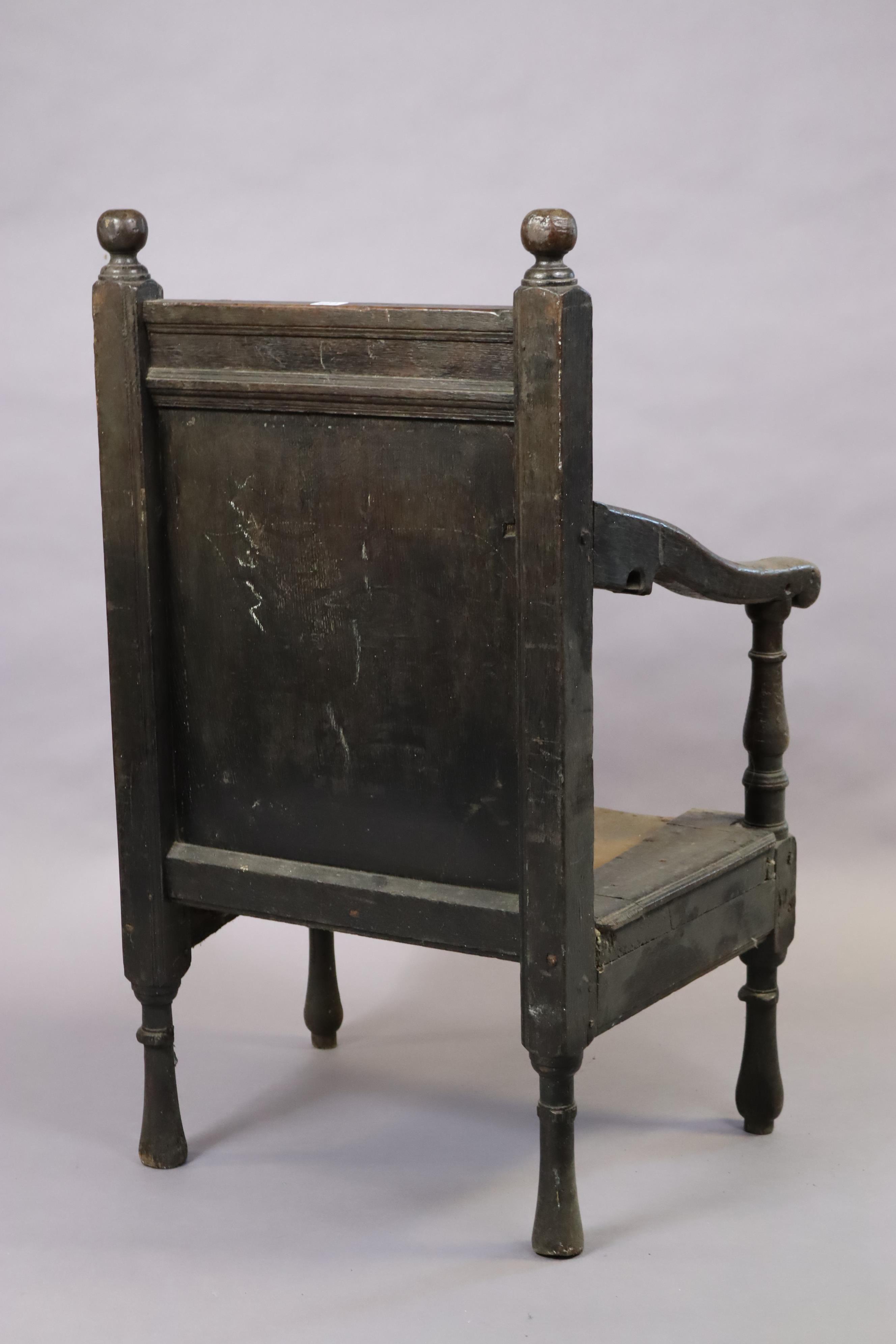 An 18th century joined oak armchair with panelled back, open scroll arms & commode seat, on turned - Image 4 of 4