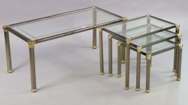 A 1970’s-style silvered-metal low coffee table inset bevelled tampered-glass top, & on four round