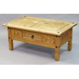 A rustic-style pine coffee table with a rectangular top, fitted centre frieze drawer, & on short