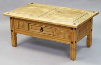A rustic-style pine coffee table with a rectangular top, fitted centre frieze drawer, & on short