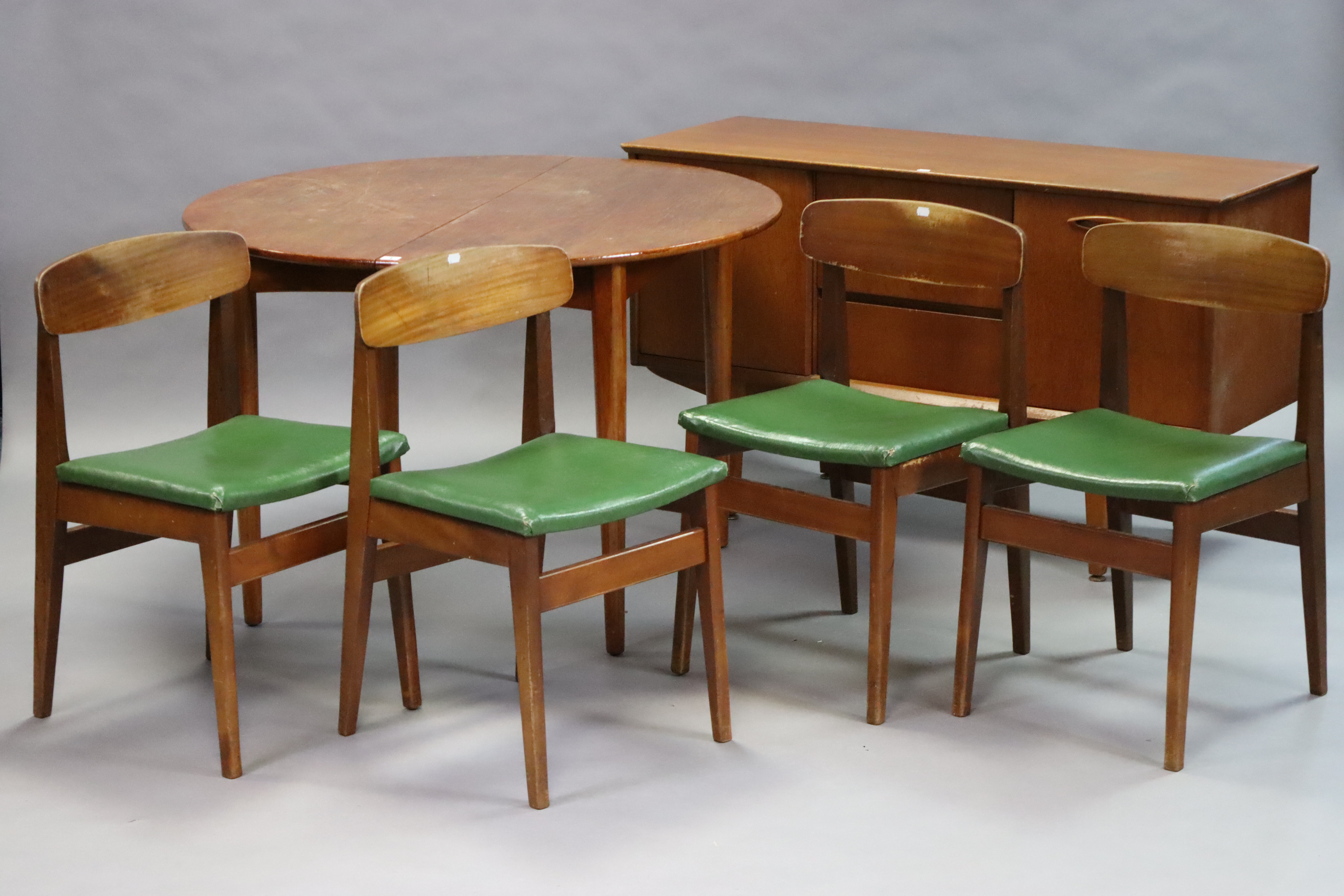 A mid-20th century teak dining room suite comprising of a circular extending table with a centre - Image 2 of 13