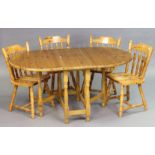 A pine drop-leaf kitchen table on four baluster-turned legs & turned feet with plain stretchers,