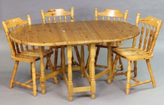 A pine drop-leaf kitchen table on four baluster-turned legs & turned feet with plain stretchers,