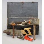 Various hand tools in a metal trunk.