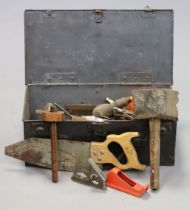 Various hand tools in a metal trunk.