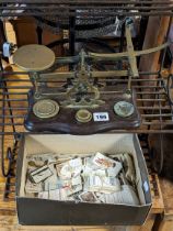 A vintage brass letter scale mounted on a mahogany serpentine-front platform base, with weights;