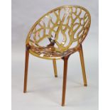 A Siesta “Crystal” contemporary amber acrylic lattice design chair.