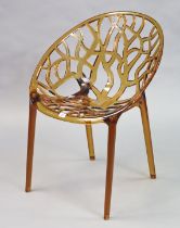 A Siesta “Crystal” contemporary amber acrylic lattice design chair.