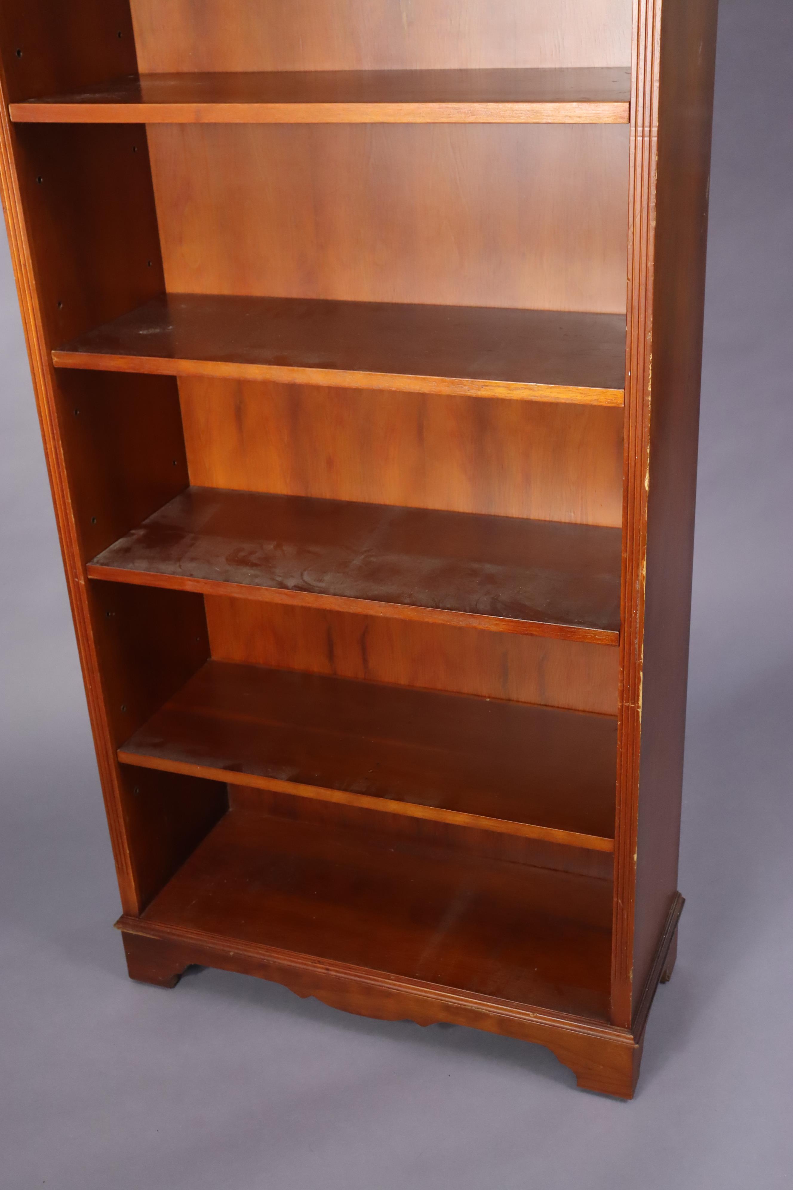 A yew wood tall standing open bookcase with five adjustable shelves, & on a shaped plinth base, 76. - Image 2 of 6
