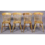 A set of four spindle-back kitchen chairs each with a hard seat, & on turned legs with turned