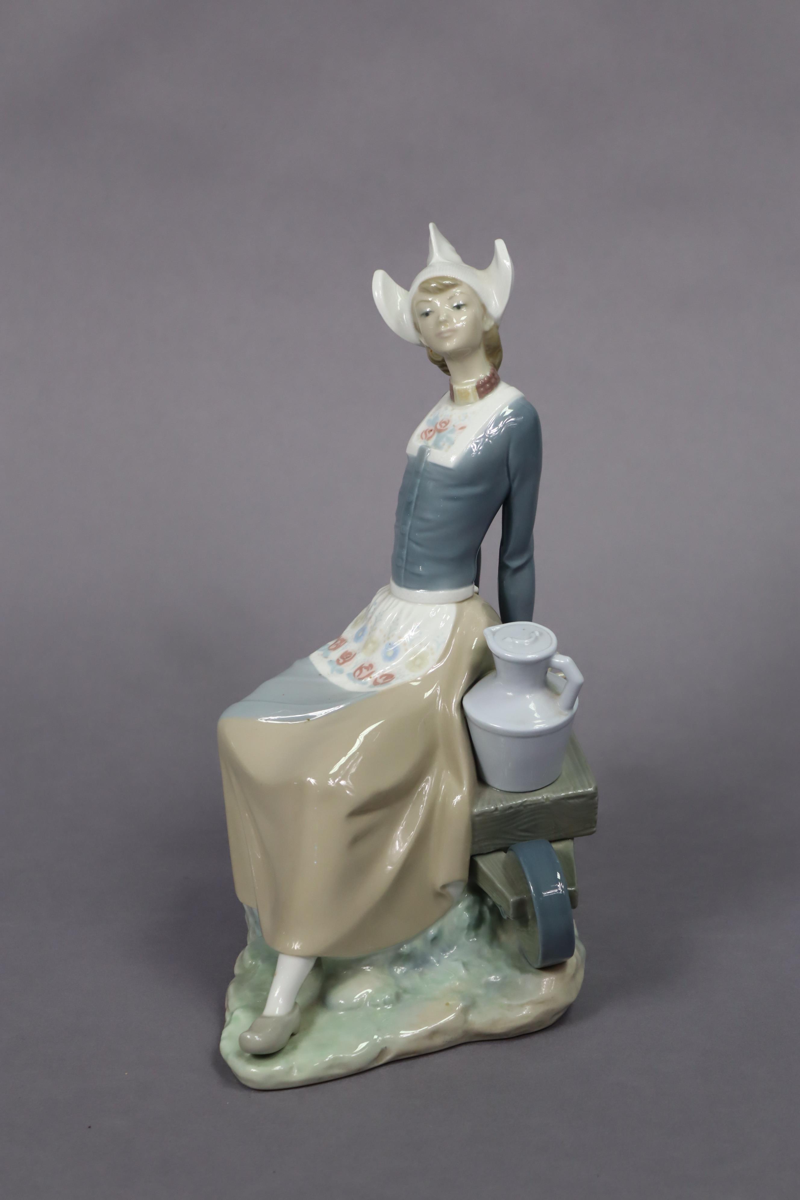 A Lladro porcelain figure of a milkmaid seated on a wheelbarrow, 32.5cm high. - Image 3 of 7