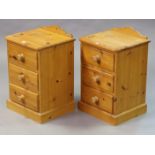 A pair of pine three-drawer bedside chests, 40.5cm wide x 63cm high.