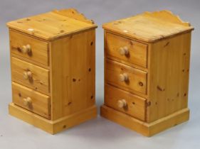 A pair of pine three-drawer bedside chests, 40.5cm wide x 63cm high.