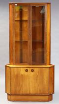 A mid-20th century teak tall standing corner cabinet by Turnidge fitted two plate-glass shelves
