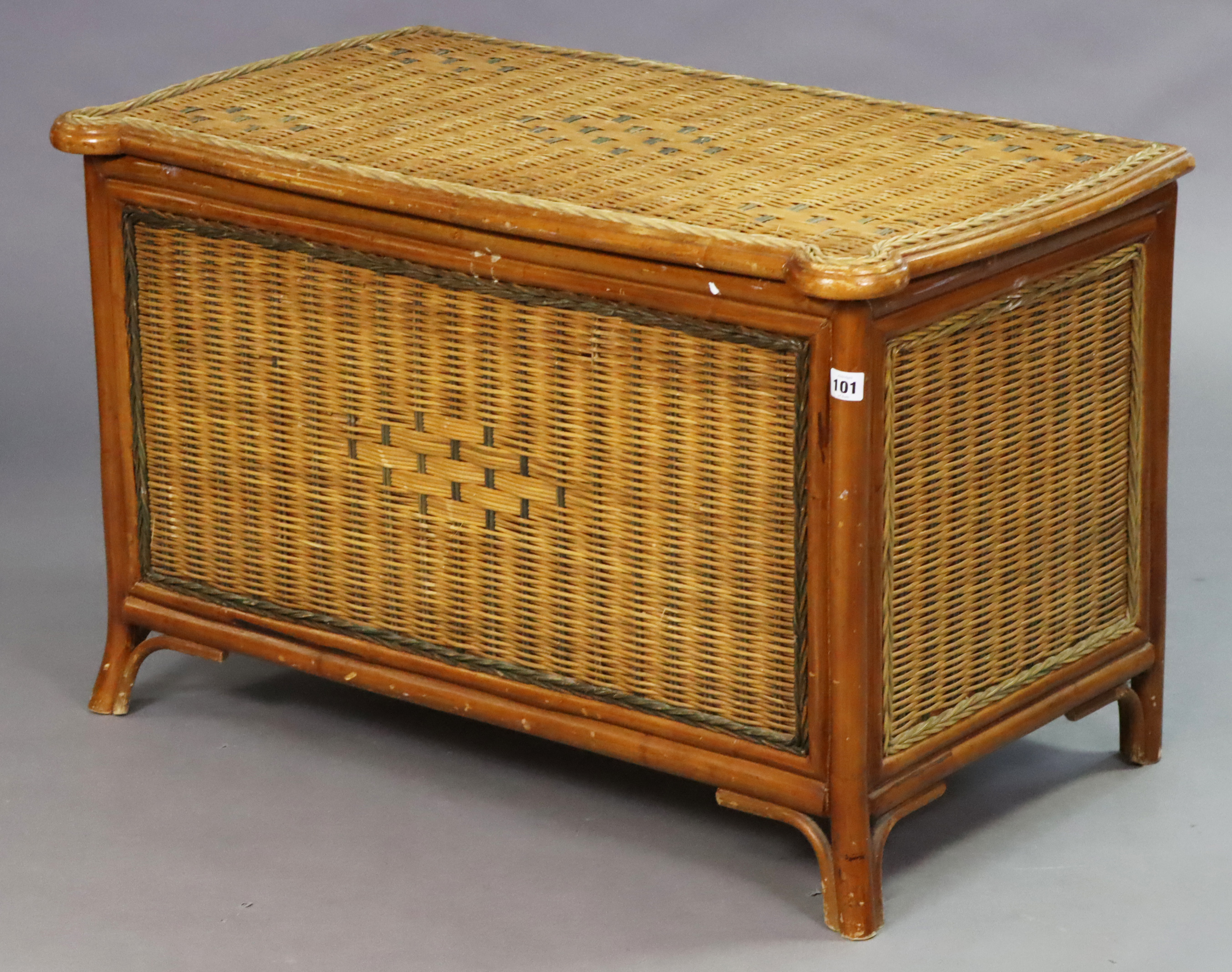 A wicker blanket box with a hinged lift-lid, 89cm wide x 55.5cm high x 51cm deep.