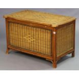 A wicker blanket box with a hinged lift-lid, 89cm wide x 55.5cm high x 51cm deep.
