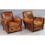 A pair of 1940s tan leather club armchairs on block feet (upholstery heavily worn).