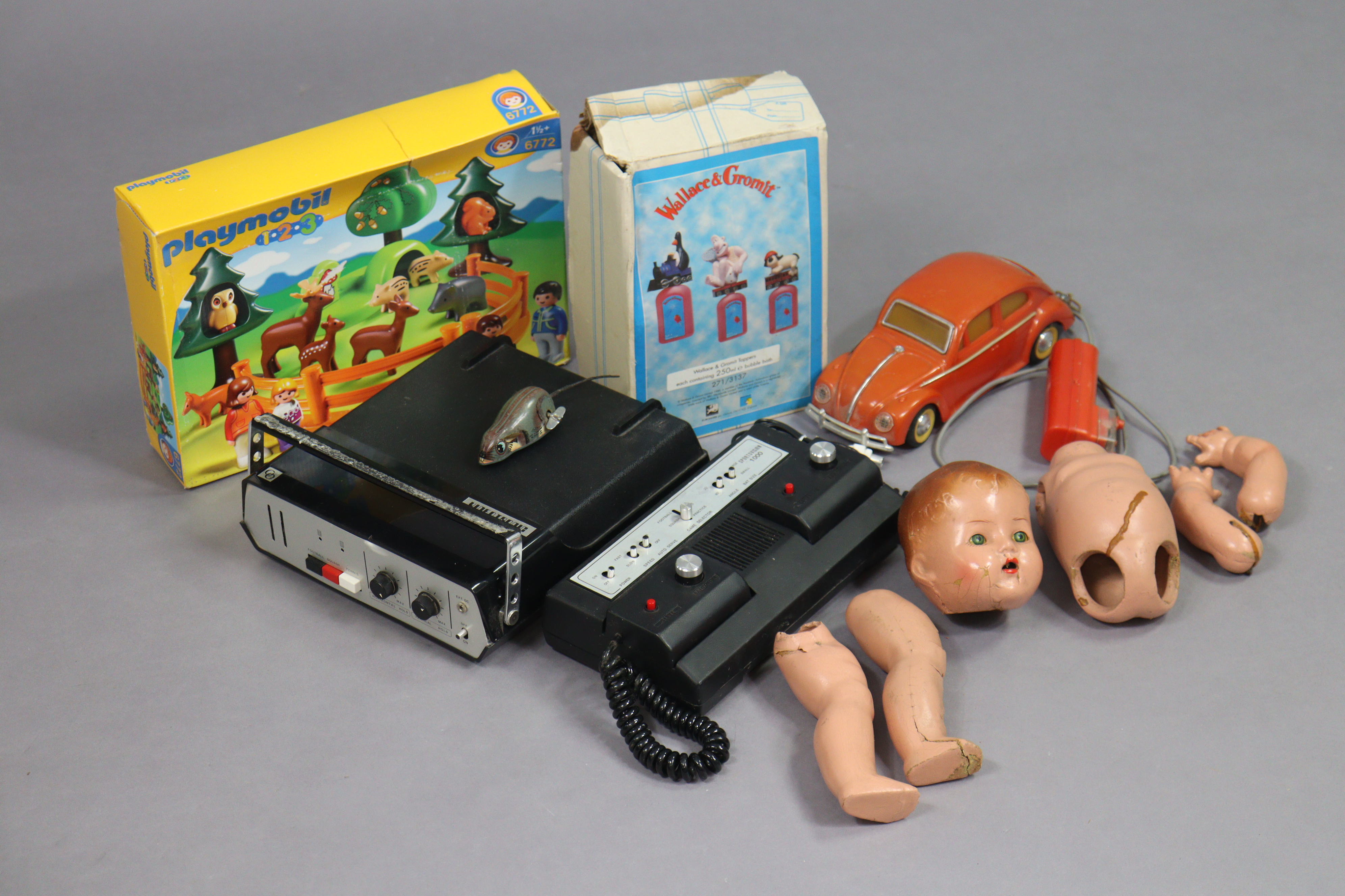 A vintage Videotronic TV game; a Sport Vision 1000 game; a composition doll & various other toys.