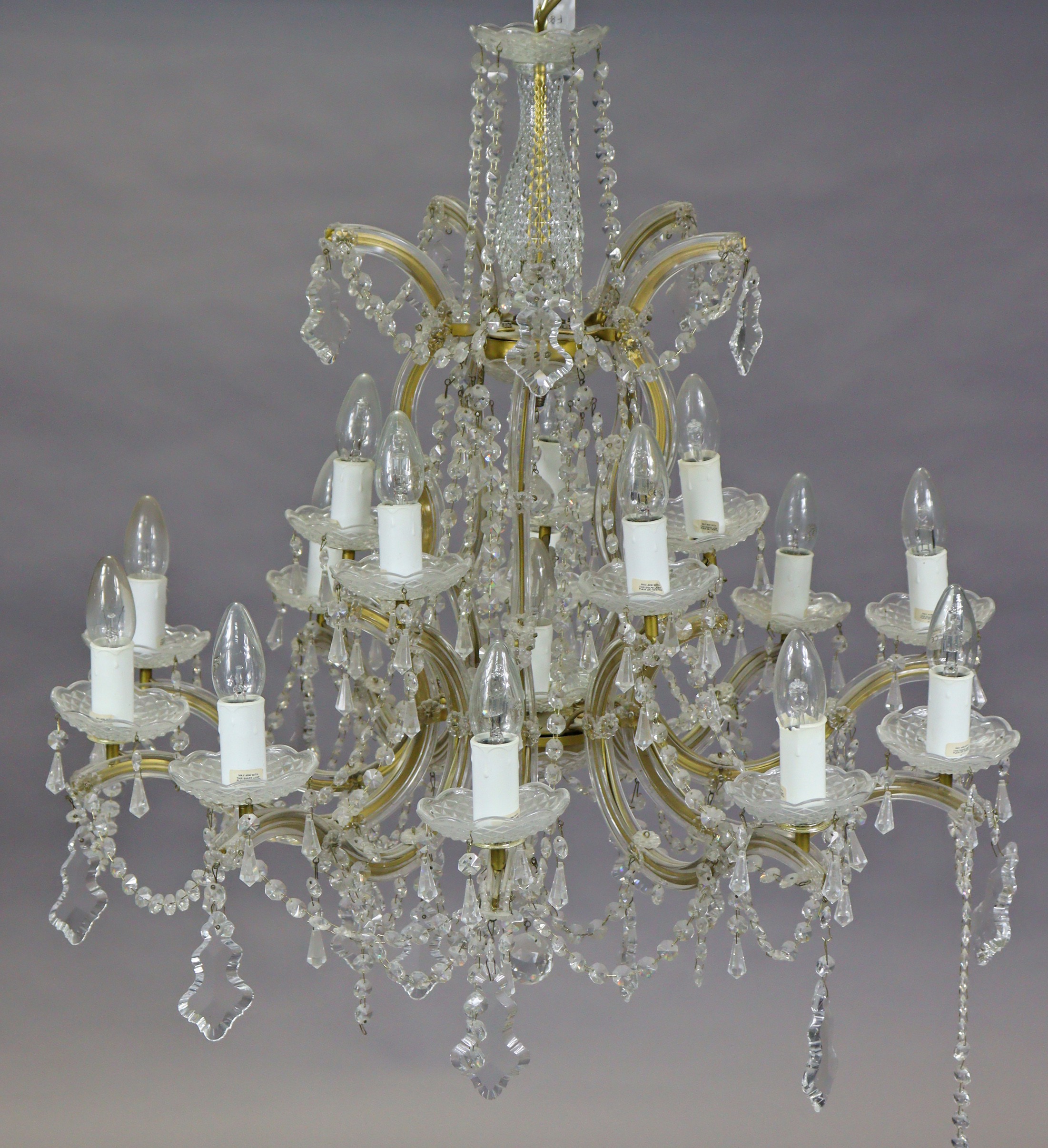 A 20th century glass 10-branch chandelier of two concentric tiers hung with prism drops, 73cm wide x