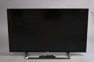 A Sony Bravia 42” colour TV with a remote control.