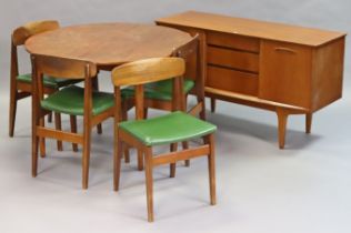 A mid-20th century teak dining room suite comprising of a circular extending table with a centre