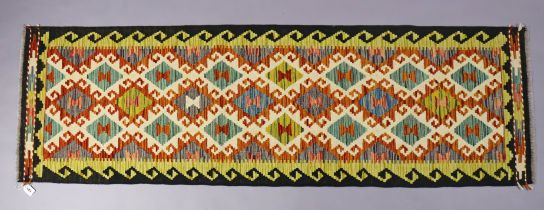 A Chobi kilim runner of multi-coloured geometric design, 202cm x 62cm.