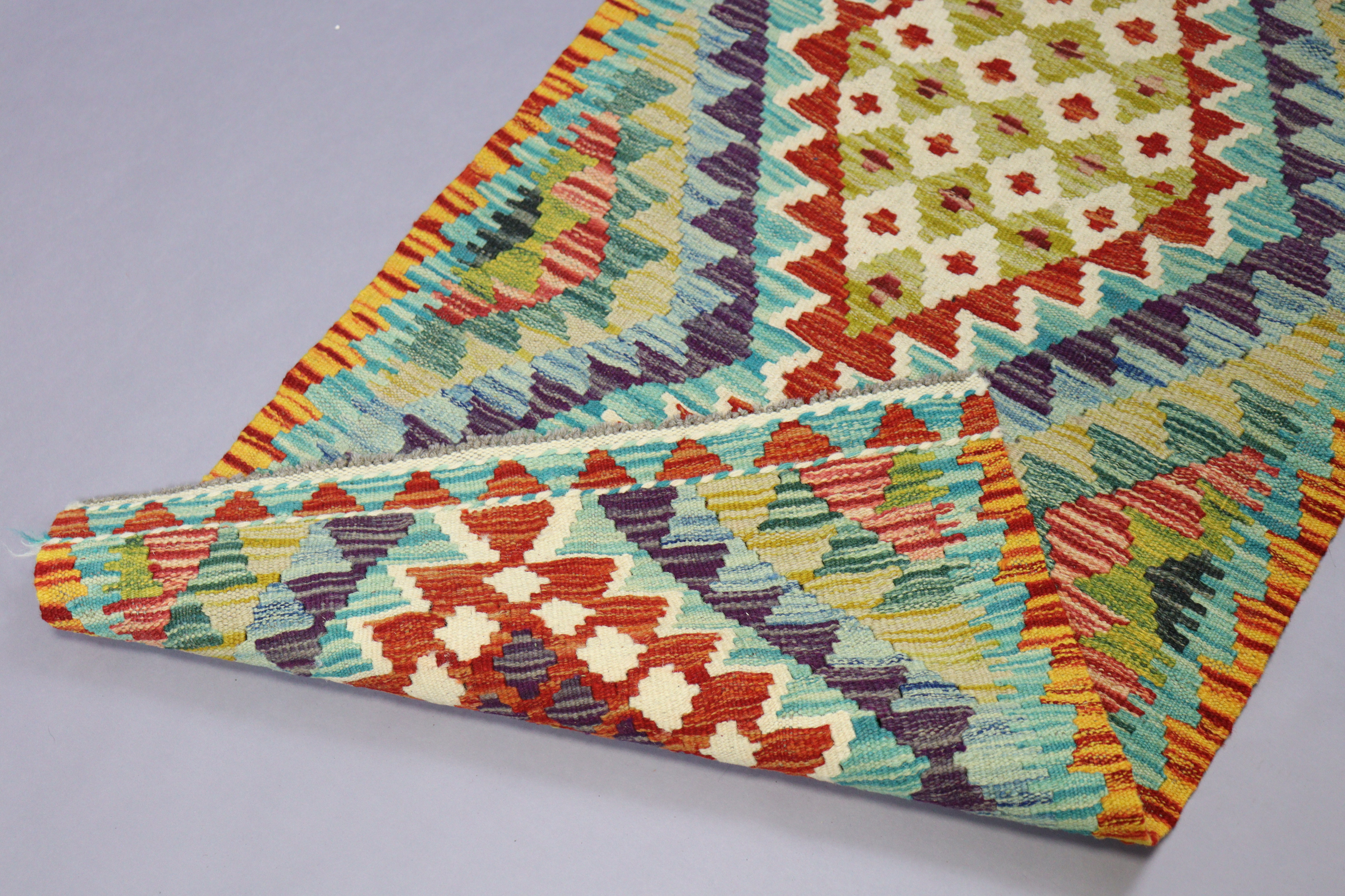 A kilim rug of beige & ivory ground & having repeating multi-coloured floral design to centre within - Image 2 of 2