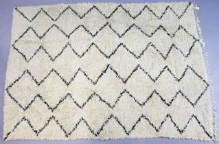 A Beni Ourain (Moroccan) rug of white ground & with all-over repeating black geometrical design,