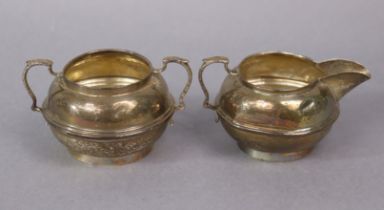 A George V silver two-handled sugar bowl & matching milk jug of compressed round form; London