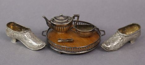 A miniature silver-mounted oak circular two-handled tea tray with pierced gallery, 7.3cm dia.; a