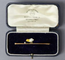 A 15ct. gold bar brooch with a chick in yellow enamel & split blister pearl; 5cm long, 2.5gm.