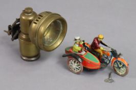 A lithographed tinplate clockwork-operated motorcycle & sidecar, with key; & a brass carbide bicycle