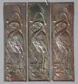 A set of three embossed metal heron-pattern door finger-plates, 26.5cm x 7.5cm.