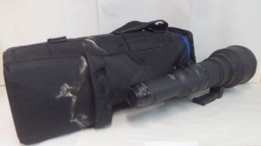 A Nikon Nikkor 800mm 1:5.6 photographic lens, in a padded bag