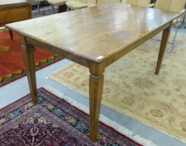 A modern oak table, raised on square, tapered legs  30"h  64"w  35"deep
