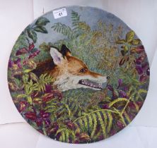 A Continental tin glazed earthenware charger, decorated with a fox in undergrowth  17"dia