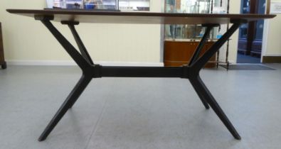A G-Plan Tola teak dining table, raised on a black painted splayed underframe  29"h  54"w
