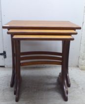 A nesting set of three G-Plan teak occasional tables  largest 20"h  22"w