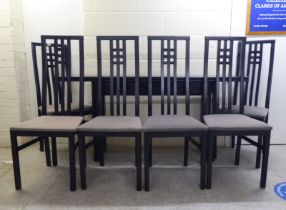 A modern Arts & Crafts style black stained and lacquered beech dining table with a foldover top,