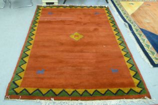 A modern woollen rug, decorated with animals, on a multi-coloured ground and zig-zag border  60" x