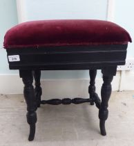 An Edwardian black painted height adjustable music stool, raised on ring turned legs