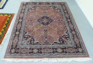 A Persian design rug with a central medallion, bordered by stylised designs, on a multi-coloured