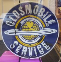 A neon sign 'Oldsmobile Service'  23"h