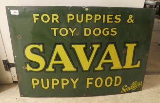 A vintage cast iron, yellow on green, enamel advertising sign for 'Saval Puppy Food'  20" x 30"