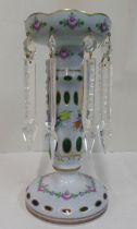 A 20thC opaque green glass lustre vase with overlaid and cut away ornament, highlighted in painted